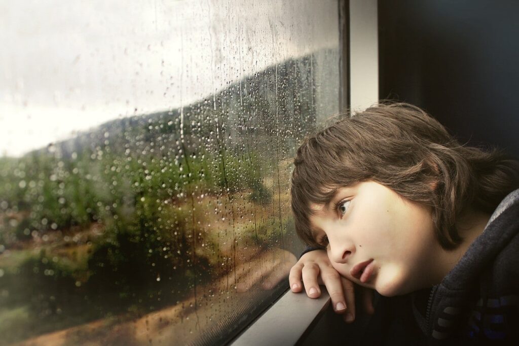 boy staring out window