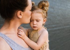 mom kissing baby girl